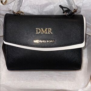 Michael Kors Black Crossbody Bag with Gold Hardware and Flap Closure